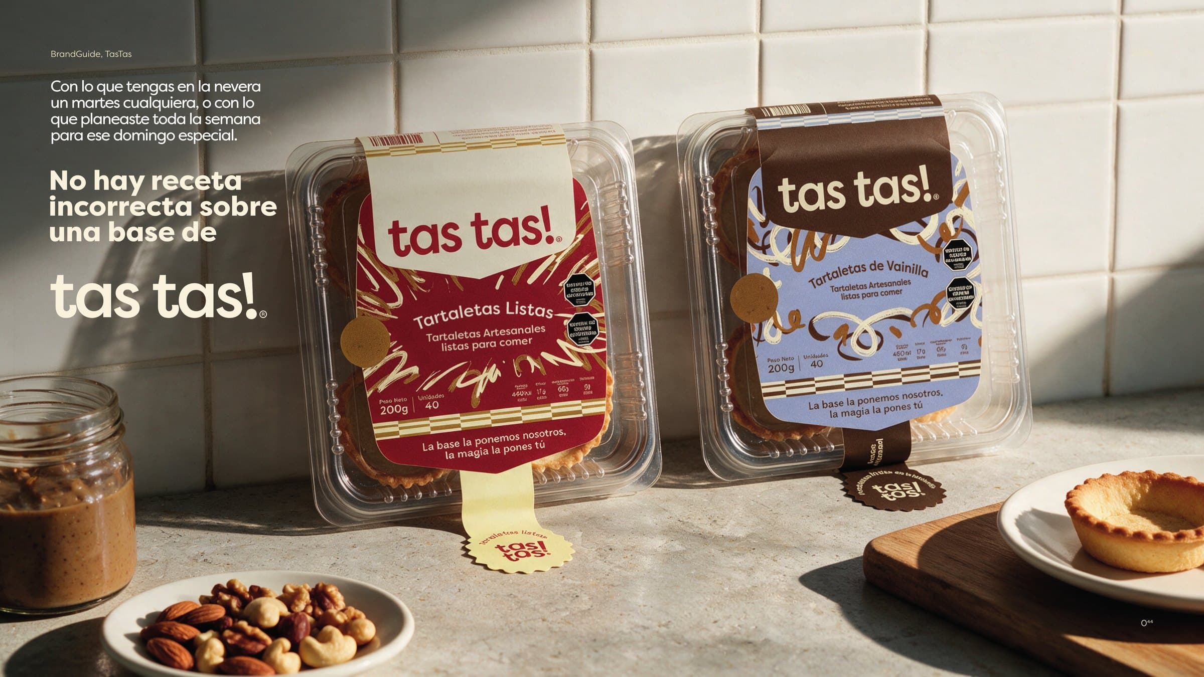 Two tas tas! packs, ready tartlets and vanilla, on a kitchen counter beside a bowl of nuts